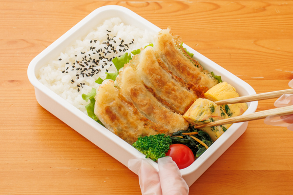 空いたスペースにかにかまとねぎのレンジ卵焼き、ほうれん草とにんじんのナムル、ミニトマト、ブロッコリーを詰める。添付のたれを添える。