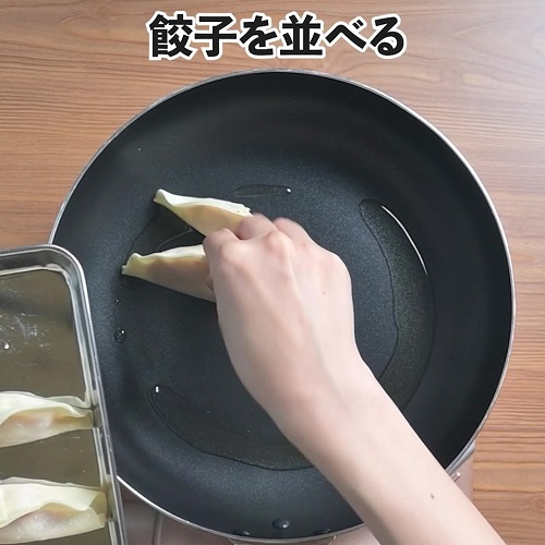 中火（鍋底に火があたる程度）にし、餃子を並べます。
